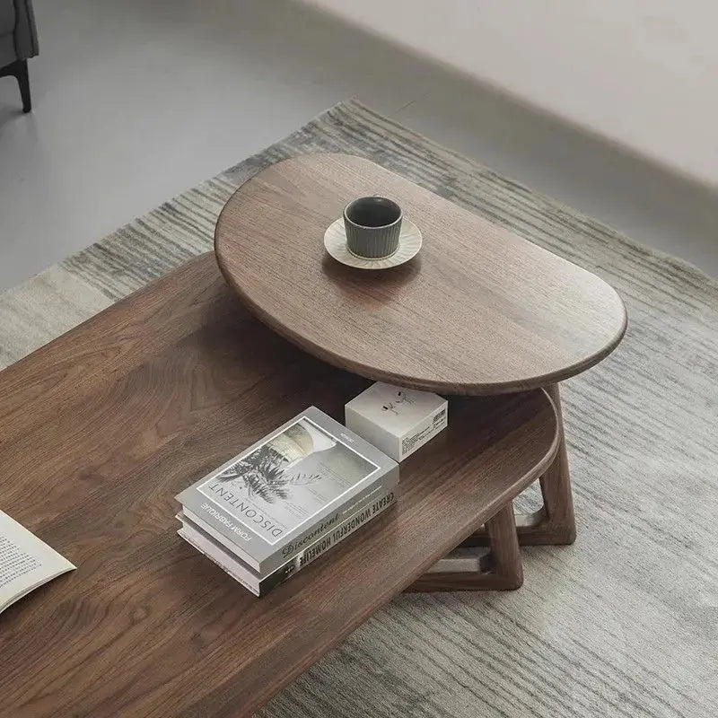 Modern wooden moving coffee table with books and a teacup, showcasing its two-tier design on a rug.