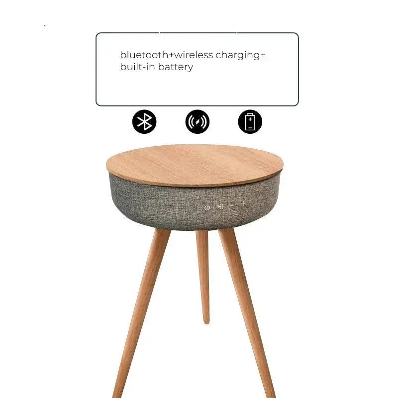 Round smart coffee table with wooden top, grey fabric speaker, bluetooth, wireless charging, and built-in battery.