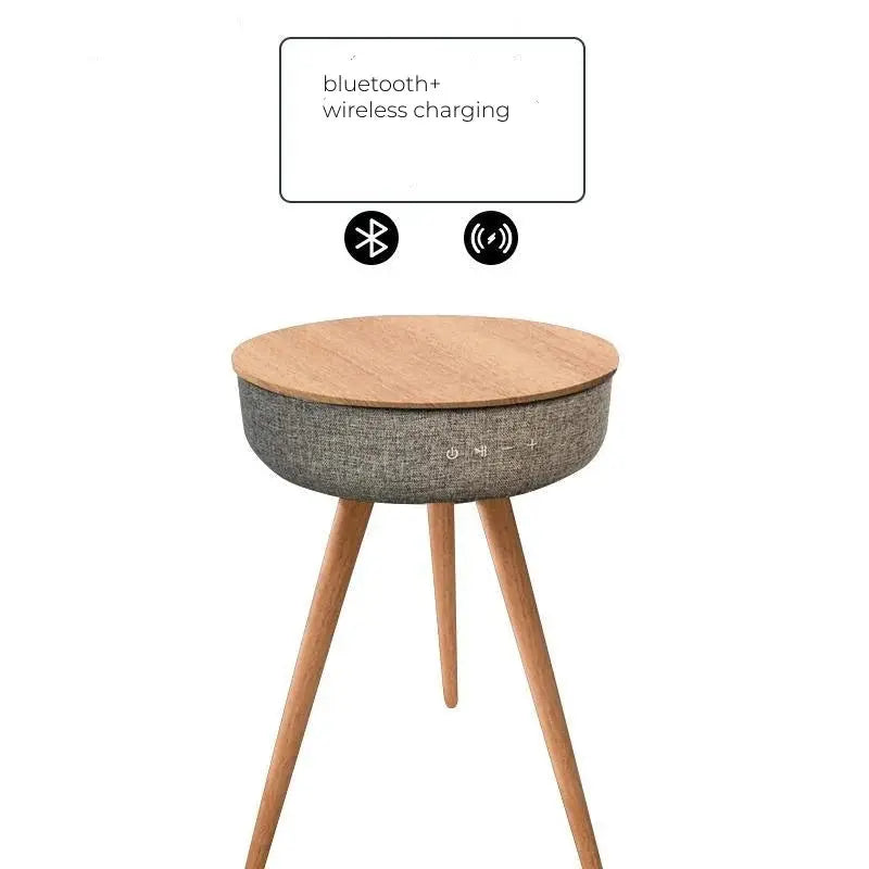 Round wooden smart coffee table with grey fabric base, Bluetooth, and wireless charging features