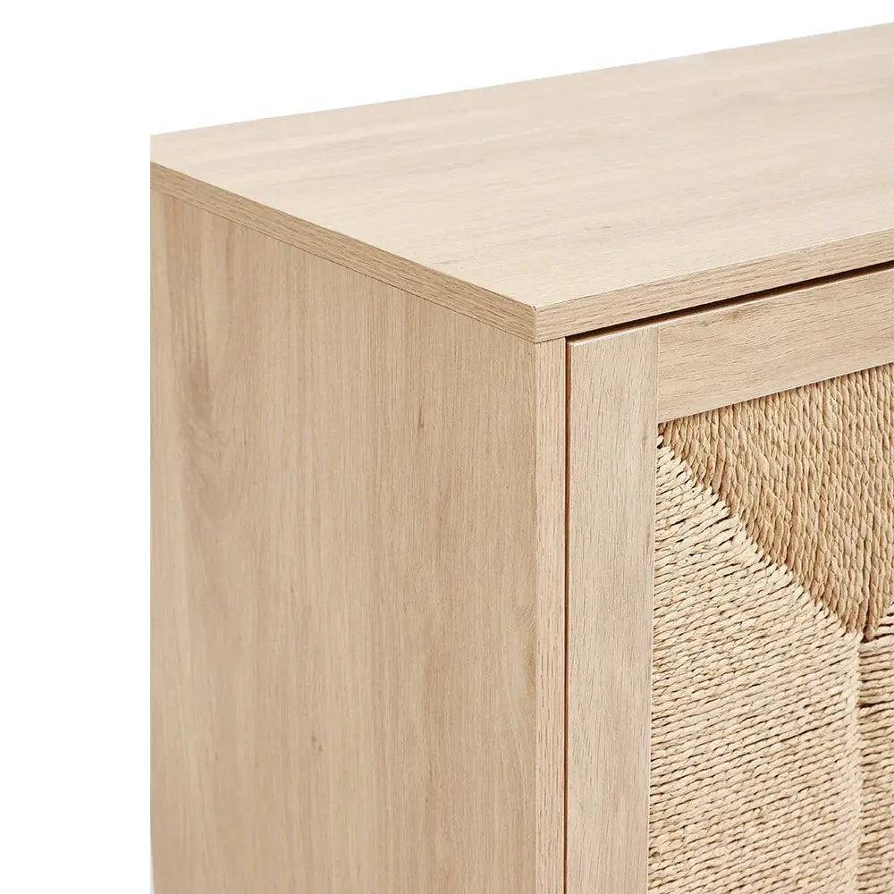 Close-up of the light wood frame and natural woven rattan door on the double door wooden sideboard.