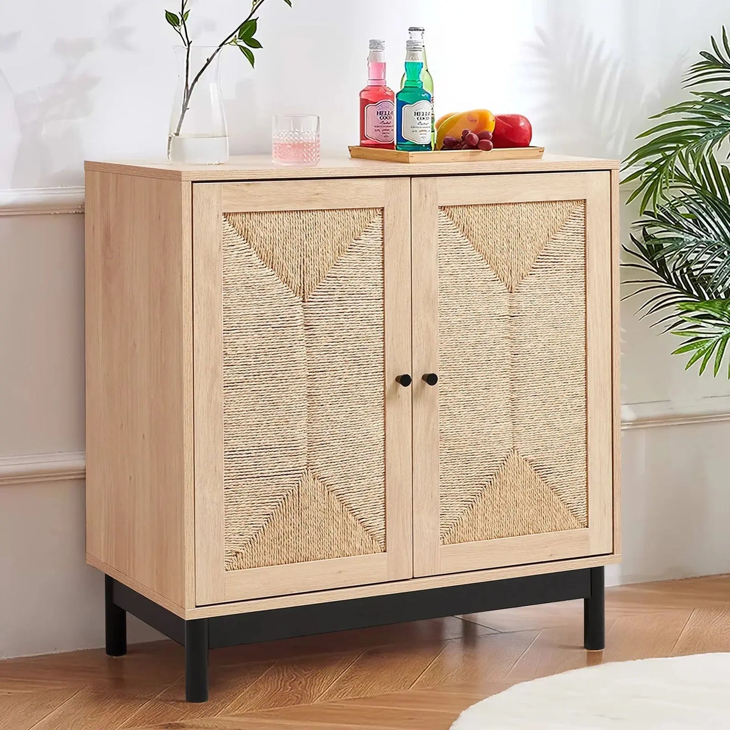 Rattan double door wooden sideboard with woven panels, black base, adorned with drinks and fruit, in a living room.
