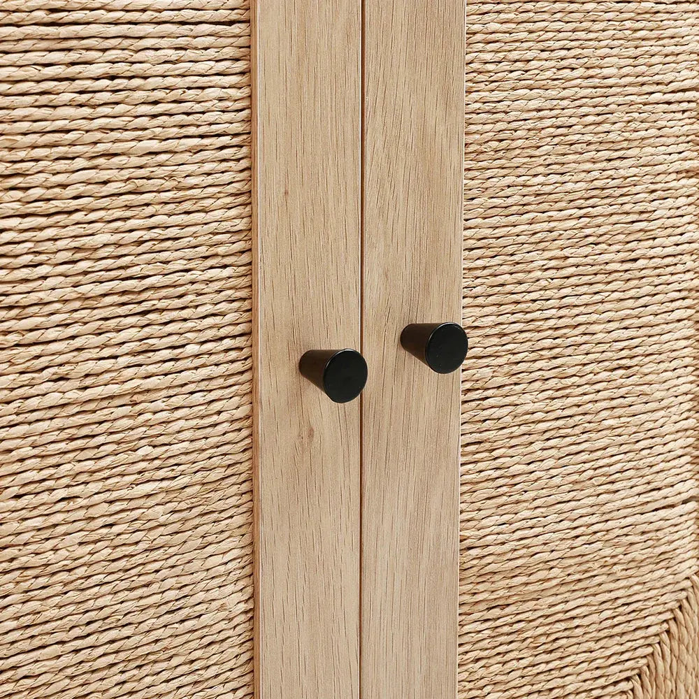 Close-up of rattan double door wooden sideboard with black handles, showing natural woven texture & wood grain