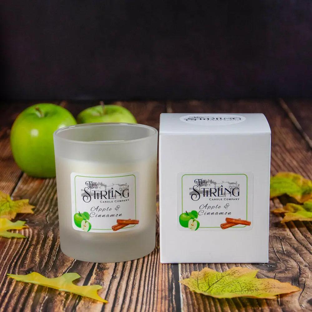 Apple & Cinnamon medium candle in frosted glass with white box, green apples, and autumn leaves on wood
