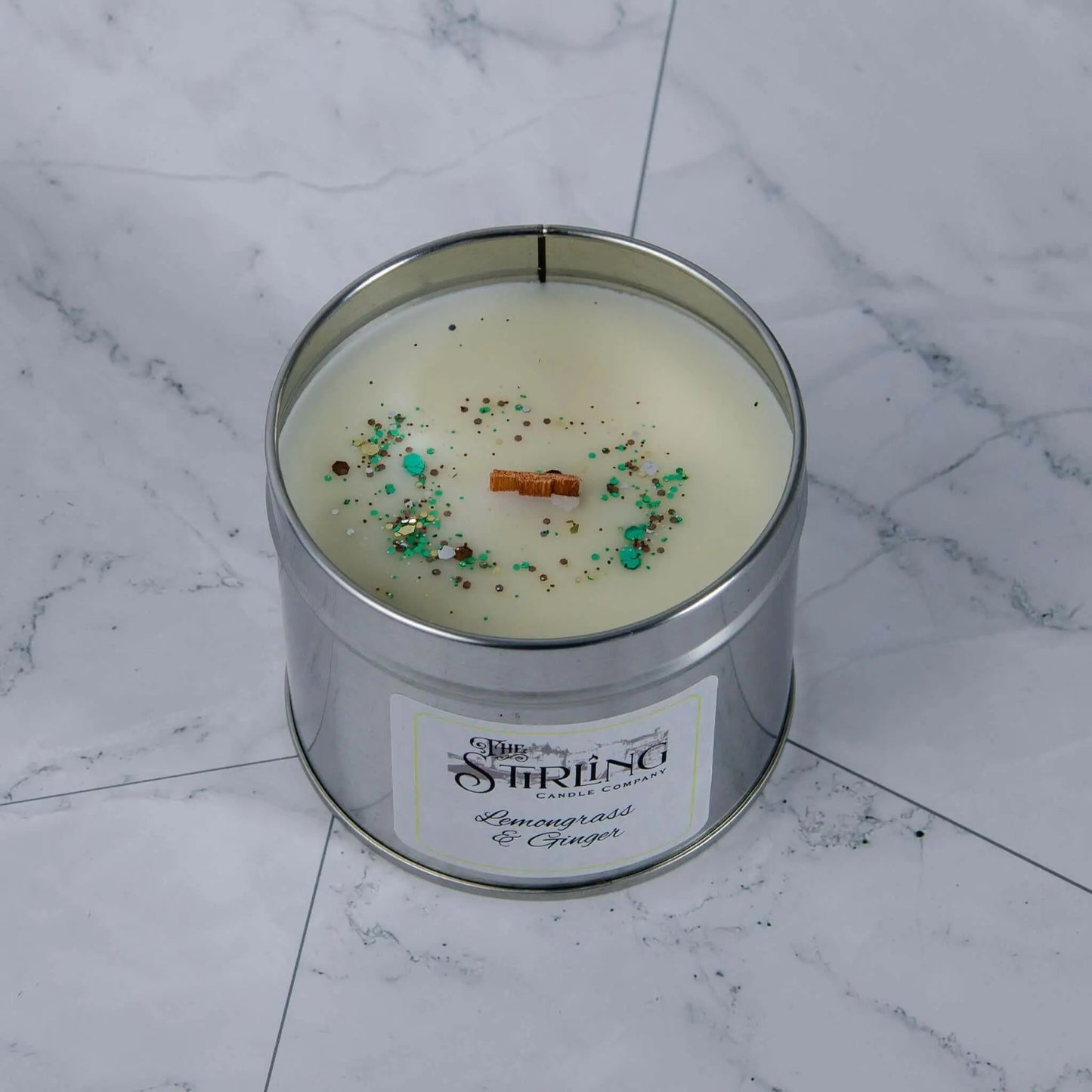Lemongrass & Ginger travel tin candle with wooden wick & label, showing rapeseed & coconut wax, handcrafted in Scotland.