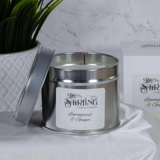 Lemongrass & Ginger travel tin candle, wooden wick, with lid open, next to its packaging
