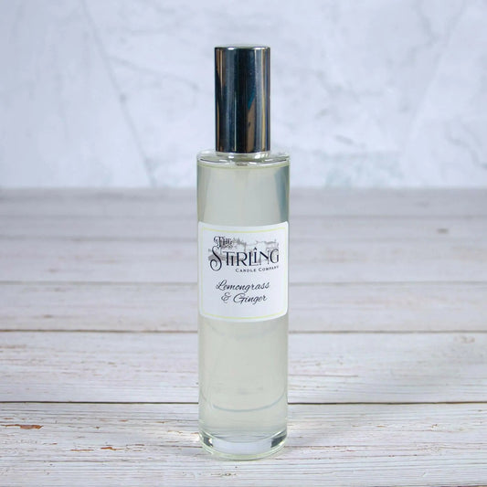 The Stirling Candle Company Lemongrass & Ginger room spray 100ml bottle with silver cap on a wooden surface.