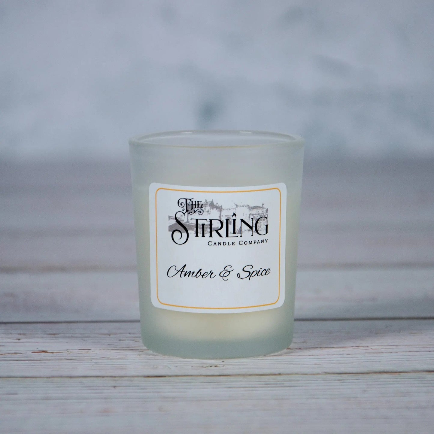 Small Amber & Spice candle in a frosted glass holder with 'The Stirling Candle Company' label, hand-poured in Scotland.