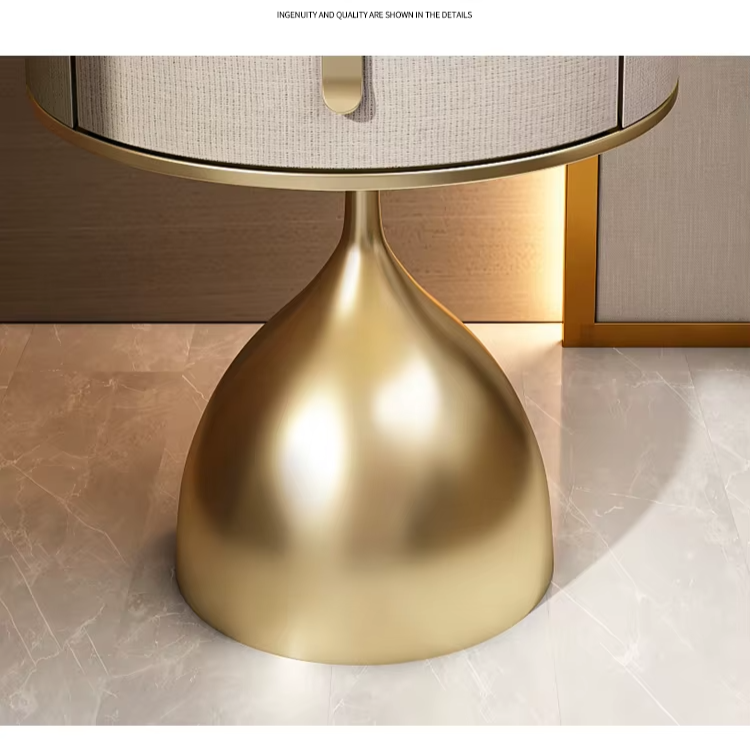 Close-up of the unique gold nightstand's teardrop base and fabric drawer with a sleek handle.