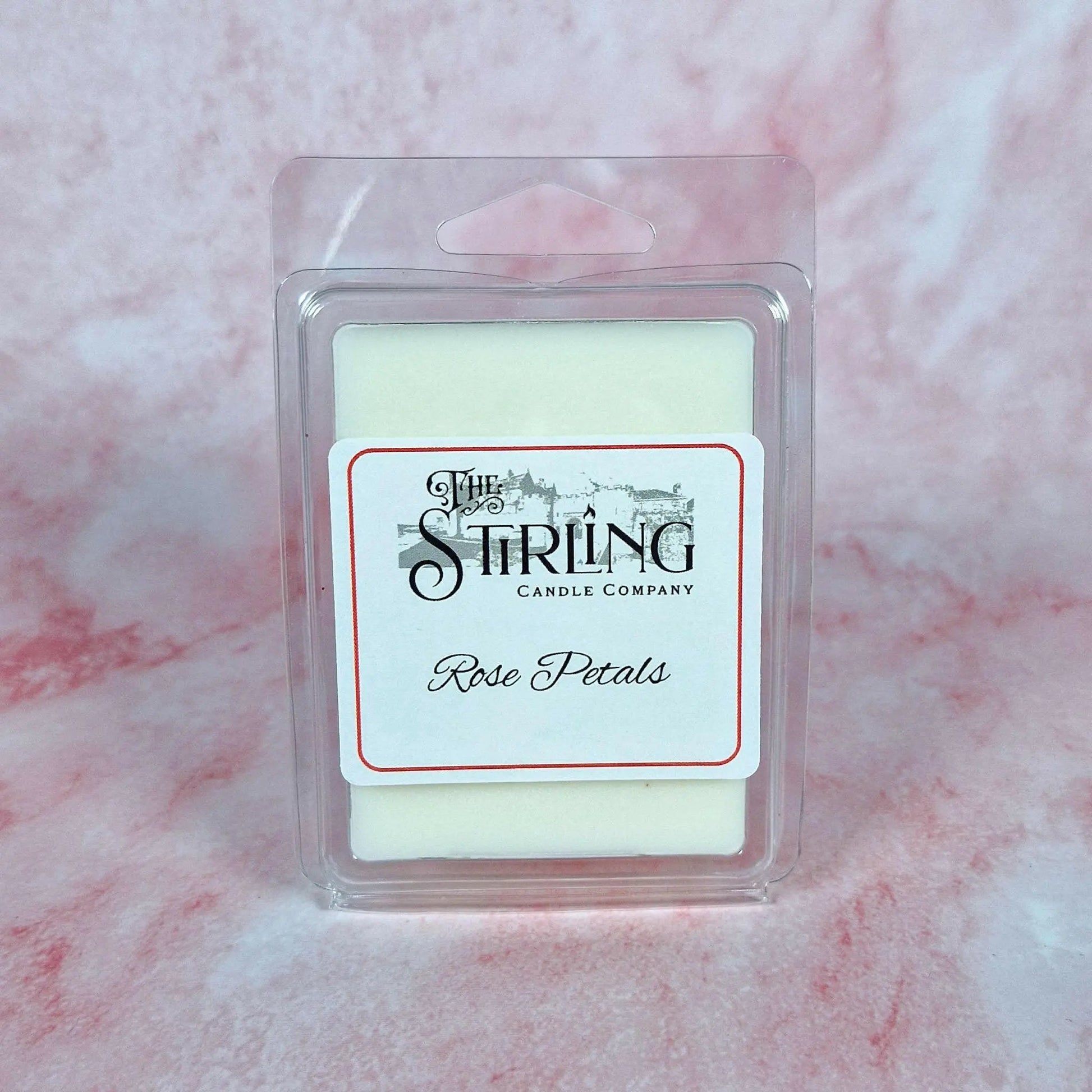 Rose Petals wax melt clamshell with white wax, red-bordered label, and 'The Stirling Candle Company' branding, on a pink background.