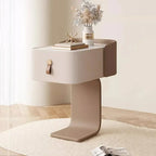 Japanese minimalist nightstand with one drawer, leather pull, and curved base, styled with a vase and books.
