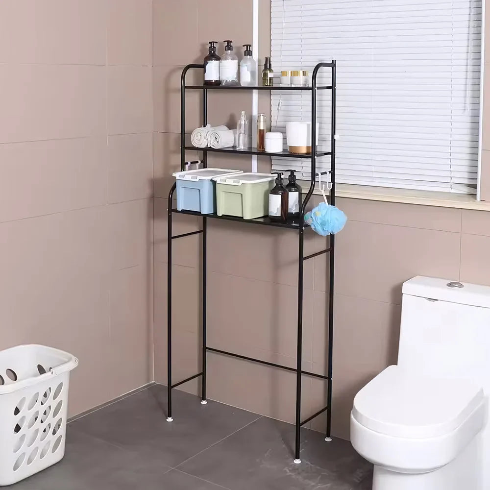 Black 3-tier over toilet storage rack in a modern bathroom, organizing toiletries and towels above a white toilet.