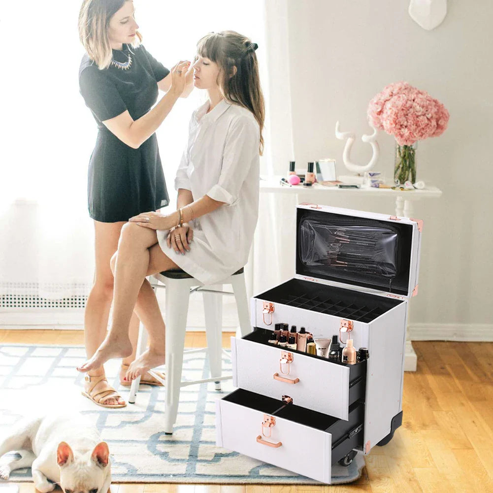 White professional rolling makeup case with open drawers, filled with cosmetics, used by a makeup artist.