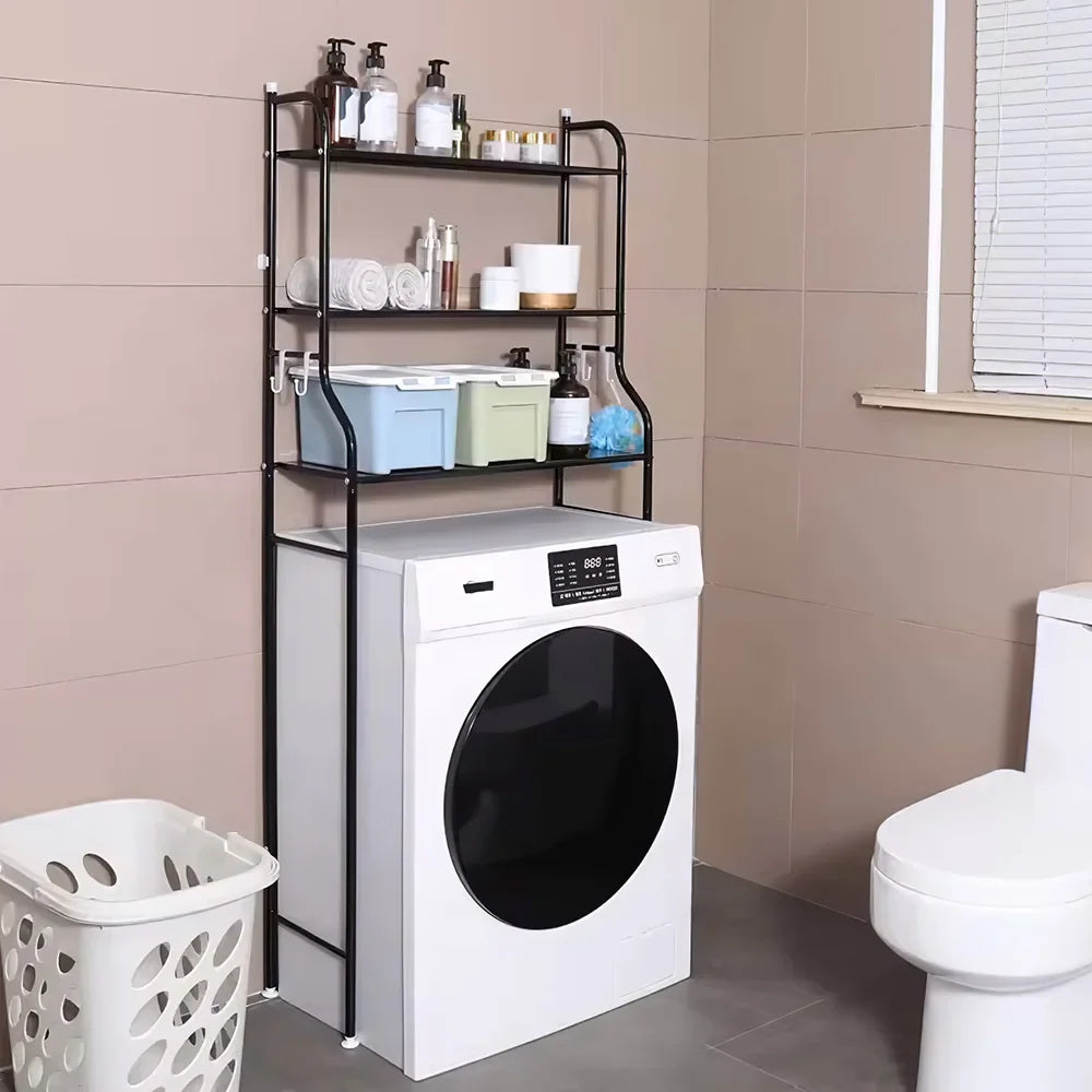 Black 3-tier over toilet storage rack with toiletries and laundry basket in a modern bathroom.