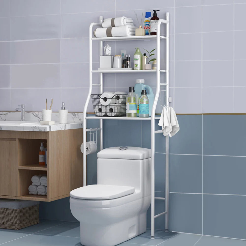 White 3-tier over toilet storage rack with toiletries and towels in a modern bathroom