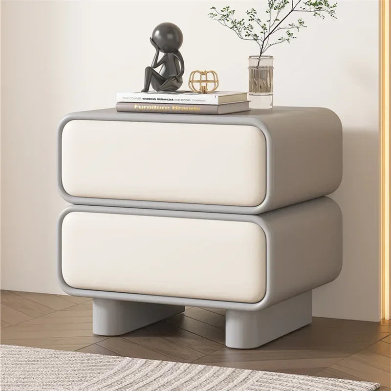 Modern Moroccan bedside table with 2 drawers, light grey solid wood frame and light cream drawer fronts, in a bedroom.