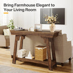 Rustic brown 2-tier entryway table behind a sofa, with decor, books, and a woven basket for storage.