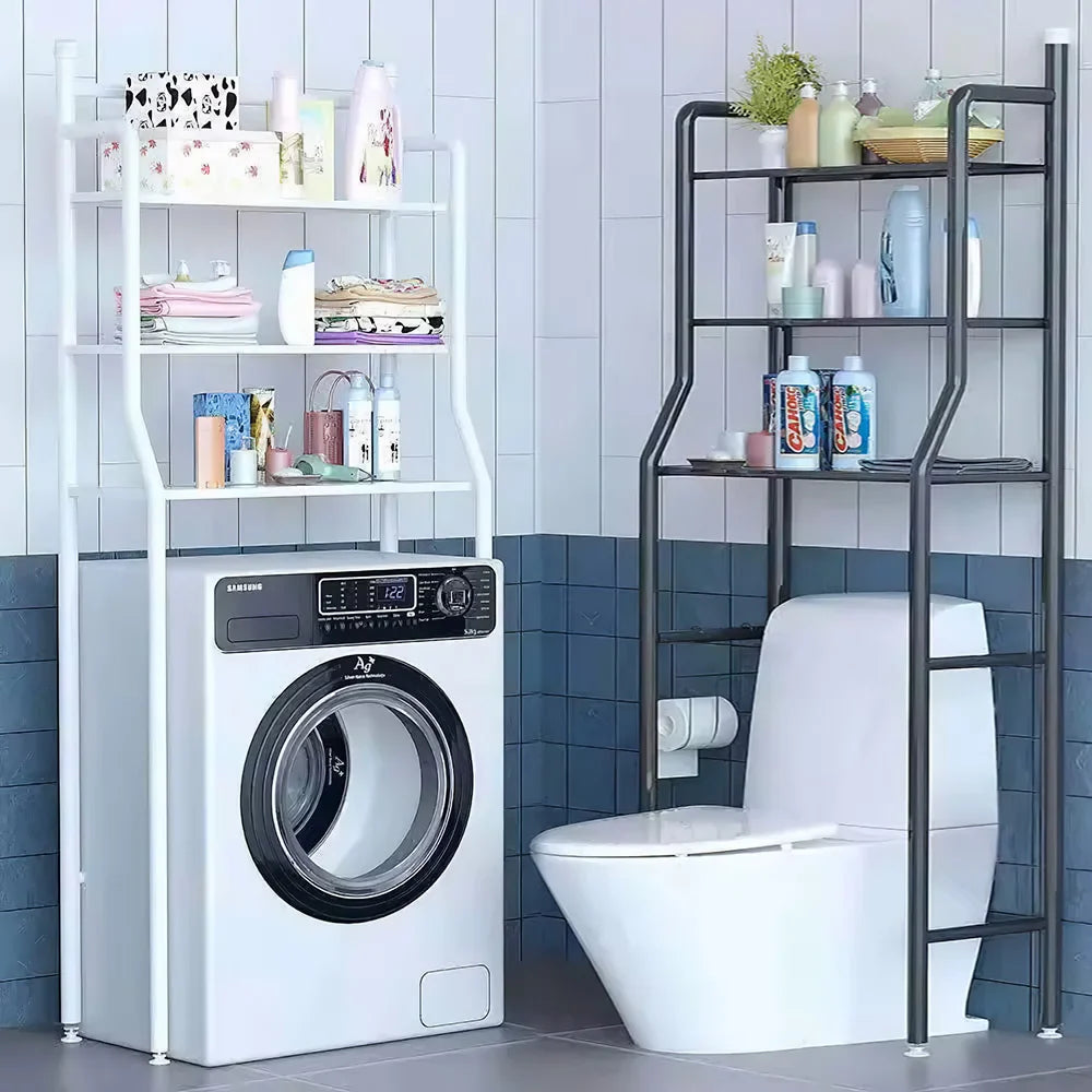 Black 3-tier over toilet storage rack with toiletries in a modern bathroom, next to a white laundry organizer.