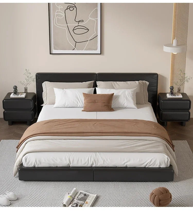 Two black modern Moroccan 2-drawer bedside tables flanking a bed in a bedroom setting.