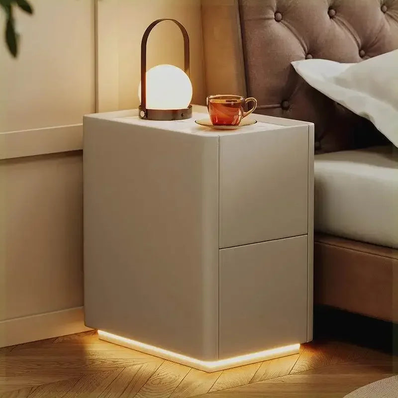 Solid wood rustic nightstand with drawers, a lamp, and a tea cup, next to a bed. Modern Morocco appearance.