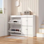 White flip-top shoe cabinet in an entryway, with two compartments open displaying shoes. Modern shoe organizer with drawers.