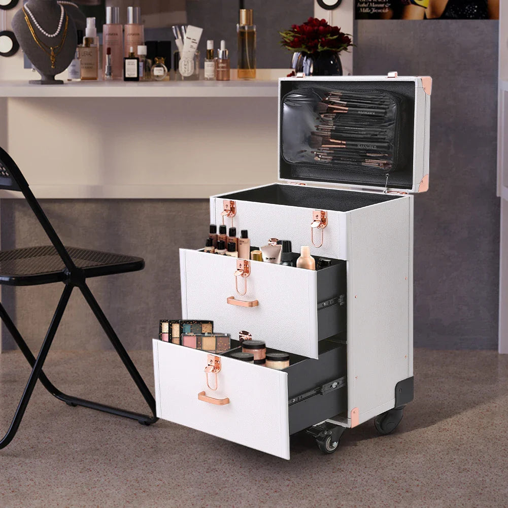 White professional rolling makeup case with open multi-layer drawers, filled with cosmetics, on wheels.