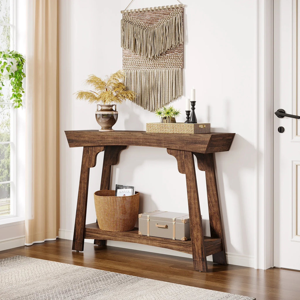 Rustic brown 2-tier entryway table with storage in a cosy hallway, decorated with a vase, candles, and woven baskets