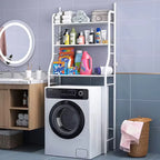 White 3-tier over washing machine storage rack in a modern bathroom, holding towels, toiletries, and laundry supplies