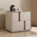 Modern beige double-layer storage bedside table with creative minimalist drawers and rounded edges on a wooden floor