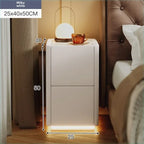Milky white modern nightstand in a bedroom with ambient lighting. It features two drawers and bottom LED lighting.