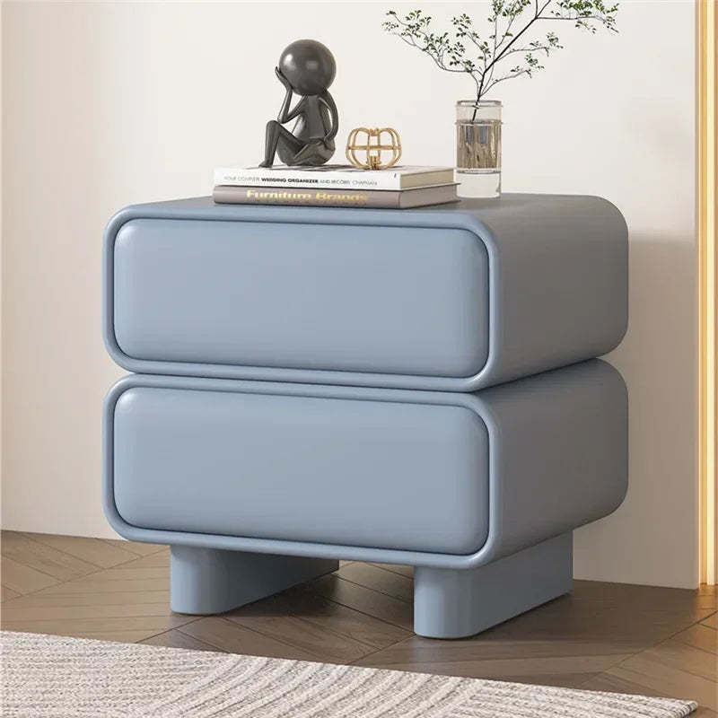Light blue modern bedside table with 2 drawers in a minimalist bedroom. Large-capacity nightstand made from solid wood.
