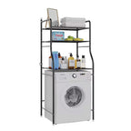 Black 3-tier over toilet storage rack with toiletries and towels, above a white washing machine.