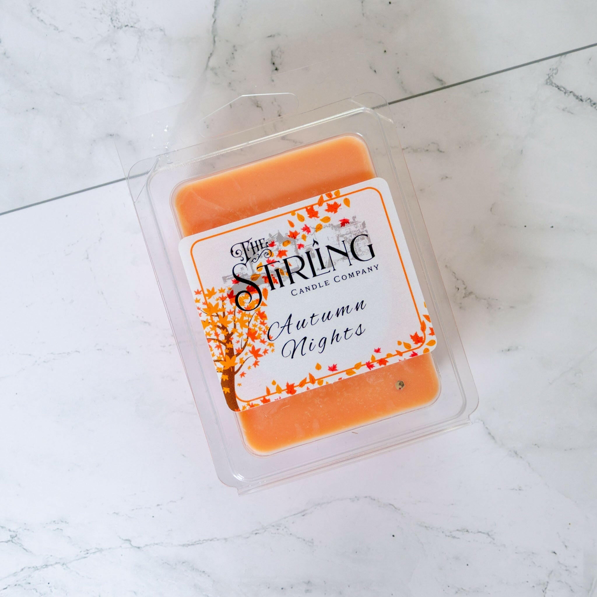 Autumn Nights wax melt clamshell by The Stirling Candle Company, orange wax with autumn leaves design