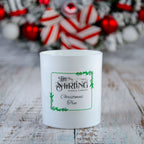Large Christmas Tree candle by The Stirling Candle Company with festive label on wood, holiday decor in background