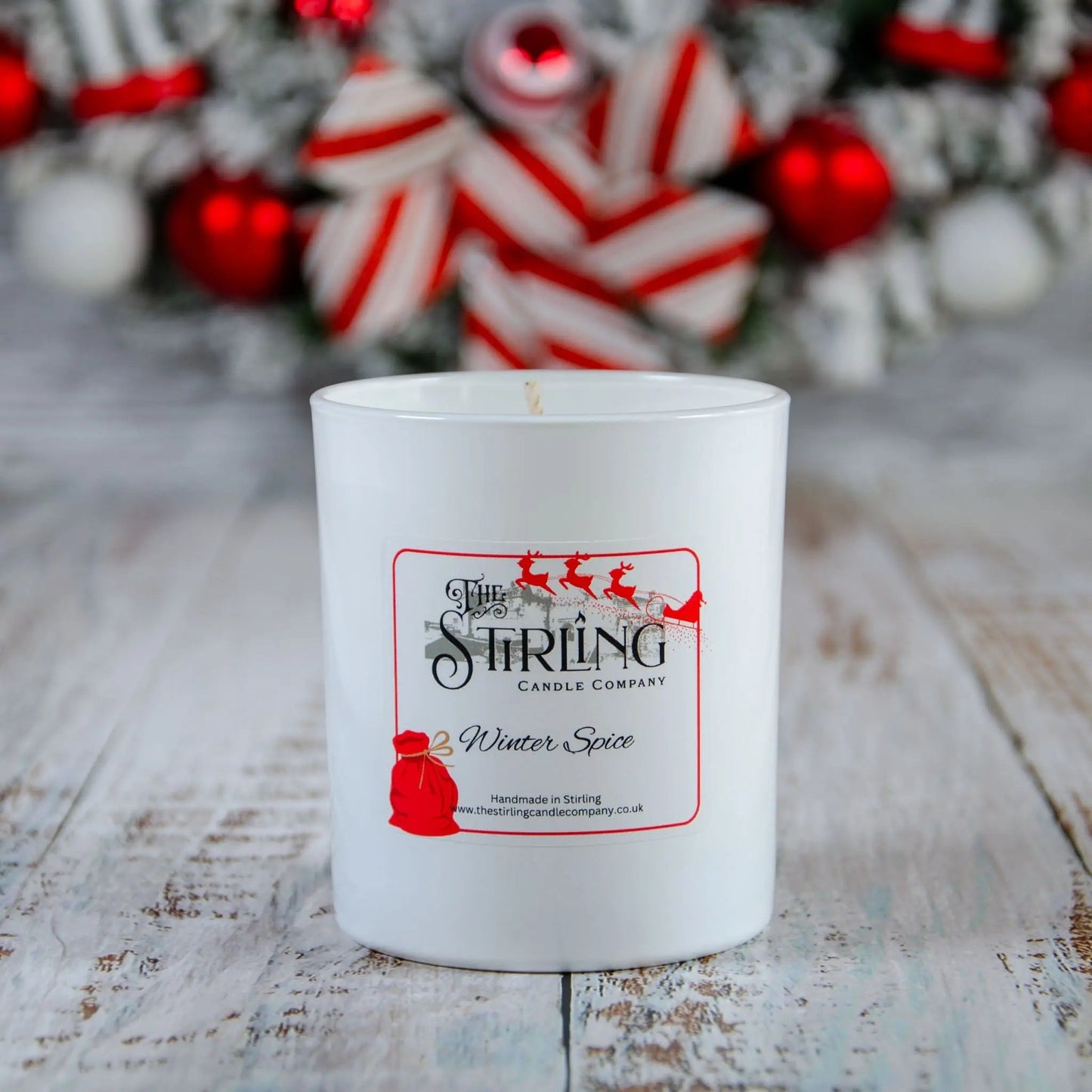 Winter Spice large candle by The Stirling Candle Company with festive background, handmade in Scotland