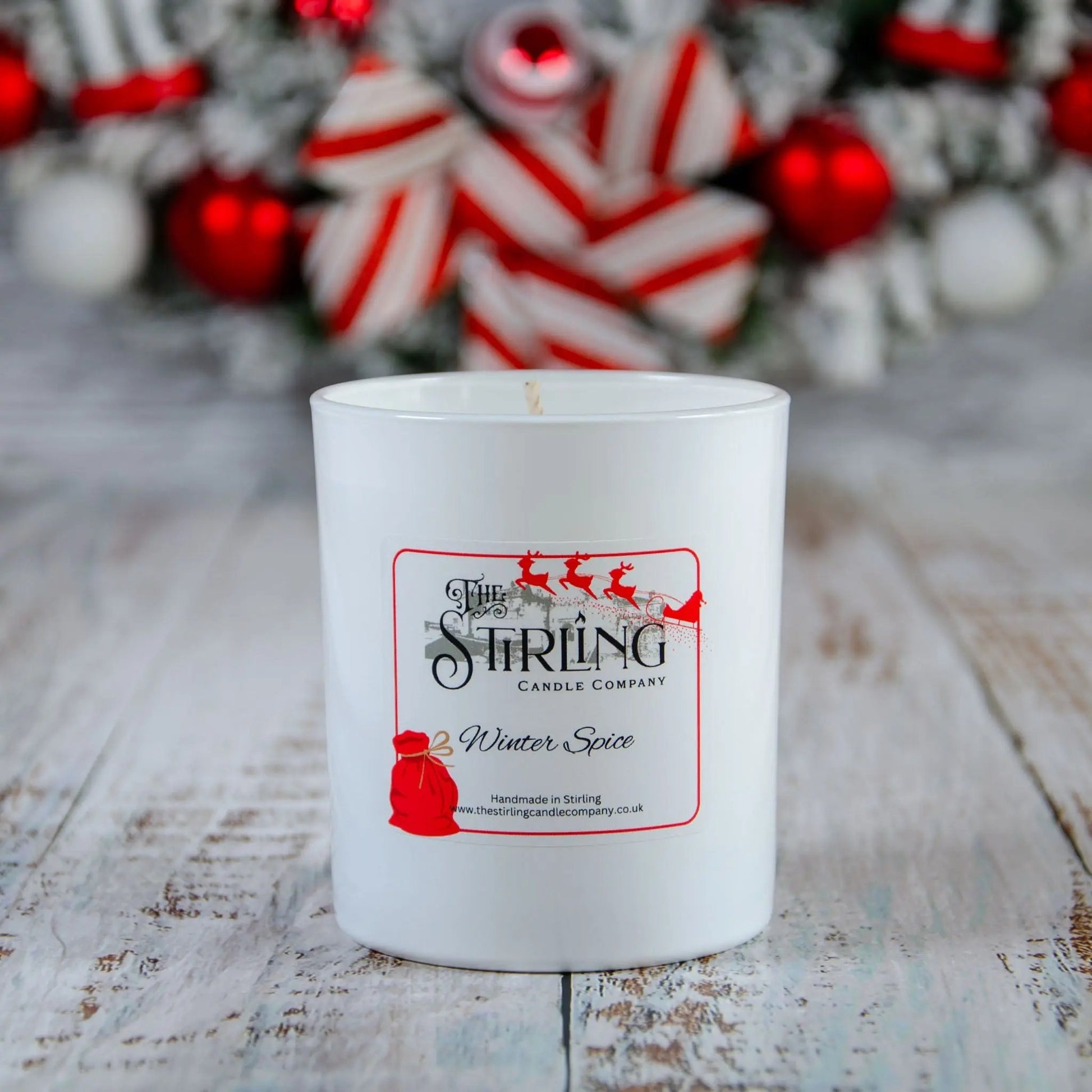 Winter Spice large candle by The Stirling Candle Company with festive background, handmade in Scotland