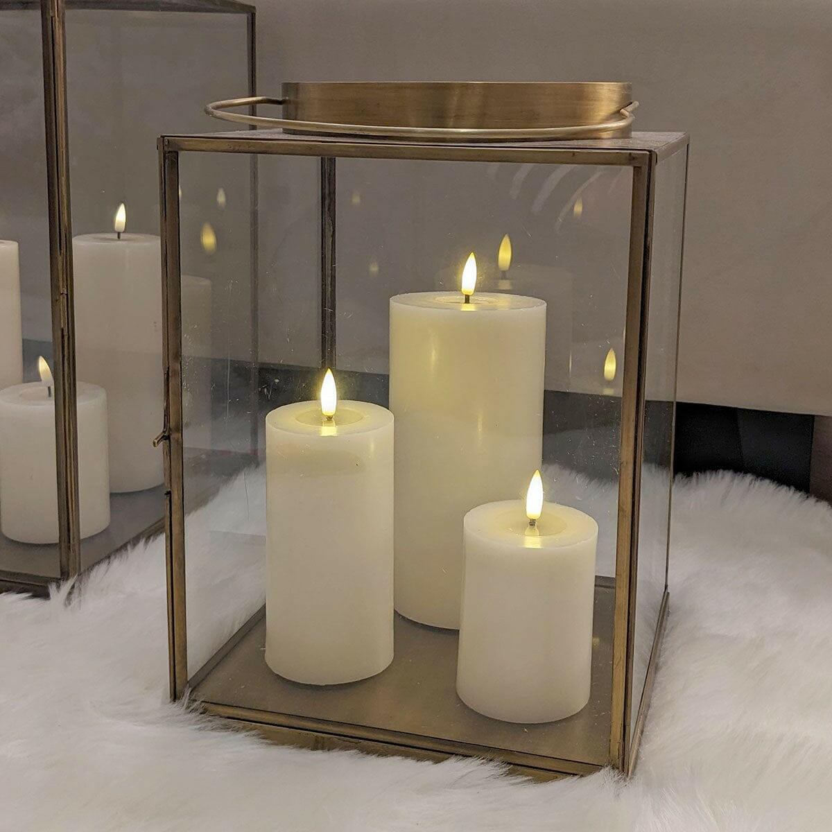 Cream Realistic LED Candles Set of 3, flameless pillar candles in a decorative lantern, warm flickering glow.