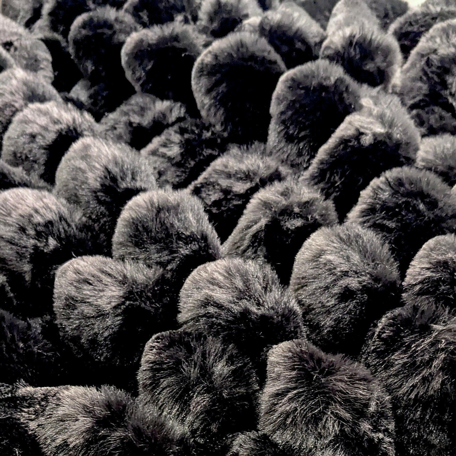 Close-up of Isla Black Chunky Ribbed Faux Fur Throw, showcasing its plush texture and deep black colour.