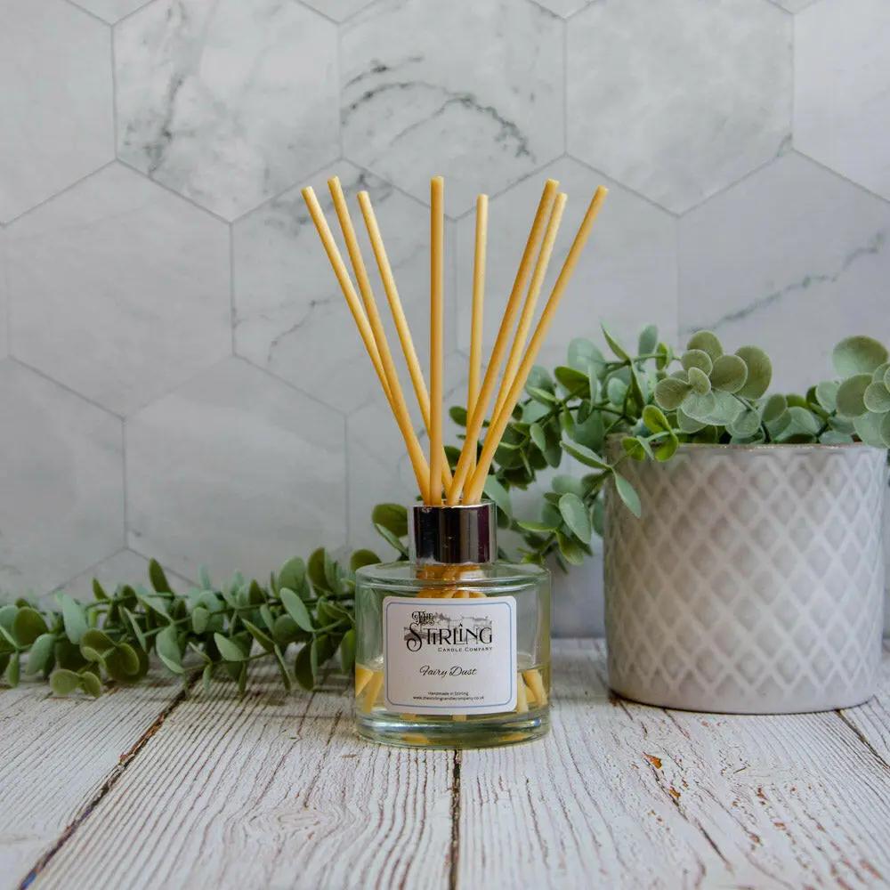 Fairy Dust 100ml reed diffuser with natural sticks, clear glass bottle, and silver top on a wooden surface.