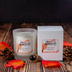 Autumn Nights Medium Candle by The Stirling Candle Company with matching packaging box, on a wooden surface.