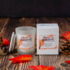 Autumn Nights small vegan candle, hand-poured in Scotland, with matching box on a wooden table with autumn leaves