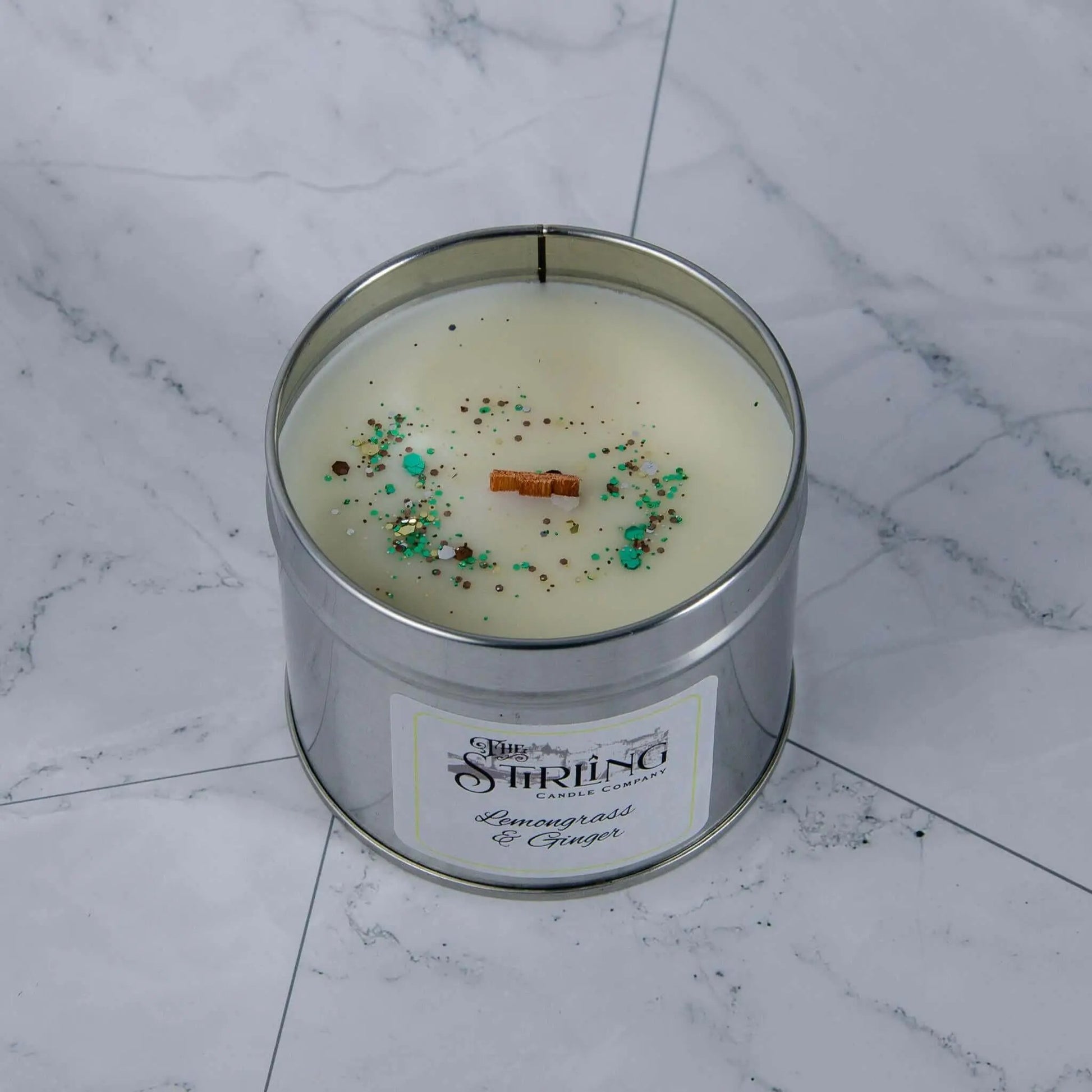 Lemongrass & Ginger travel tin candle with wooden wick & label, showing rapeseed & coconut wax, handcrafted in Scotland.