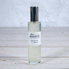 The Stirling Candle Company Lemongrass & Ginger room spray 100ml bottle with silver cap on a wooden surface.