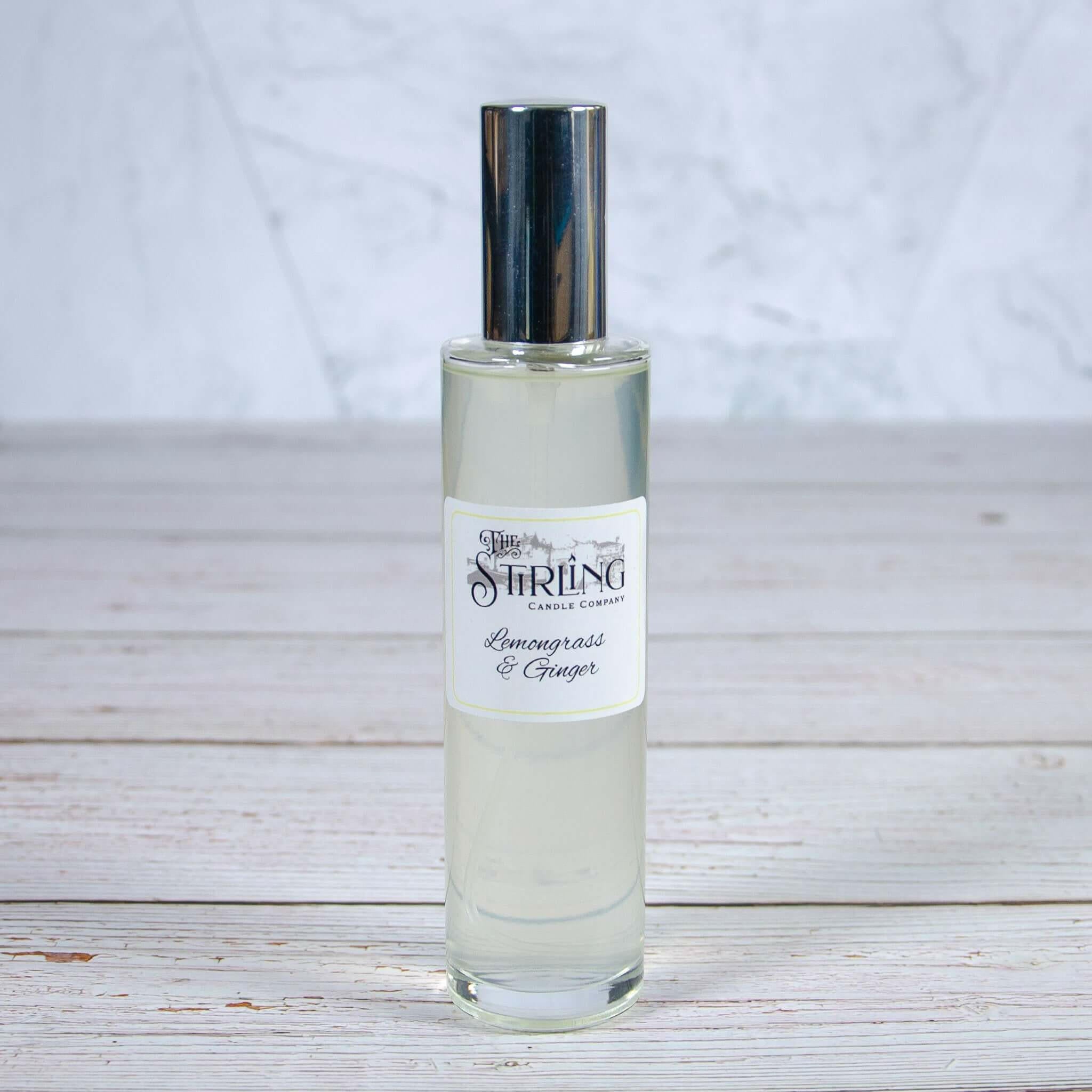 The Stirling Candle Company Lemongrass & Ginger room spray 100ml bottle with silver cap on a wooden surface.