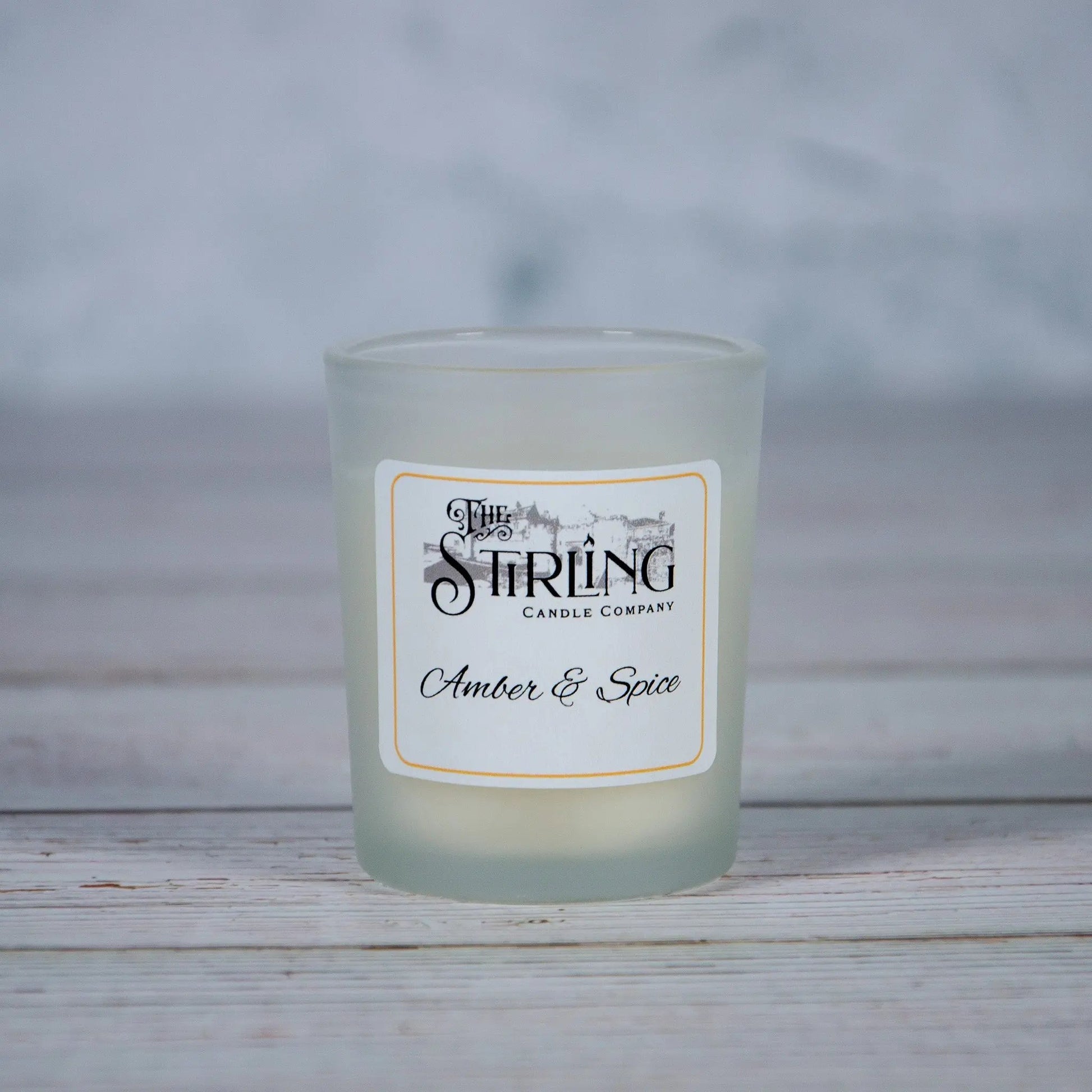 Small Amber & Spice candle in a frosted glass holder with 'The Stirling Candle Company' label, hand-poured in Scotland.